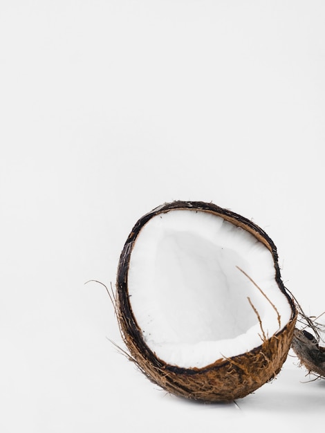 Free Photo halved coconut shell against white background