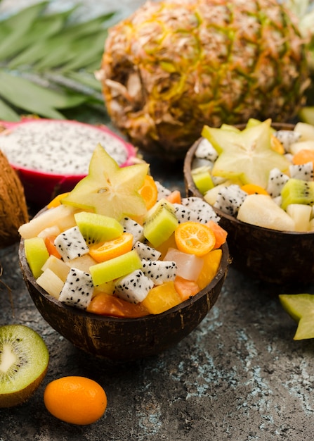 Free Photo halves of coconut filled with fruit salad