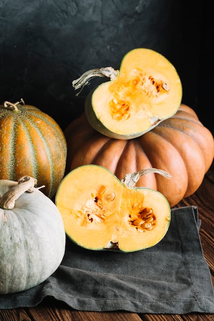 Halves of ripe pumpkin on a black cloth