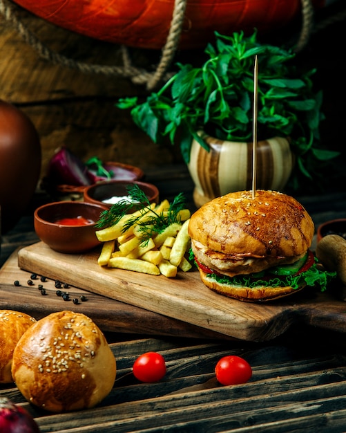 Free photo hamburger served with herbs and fries