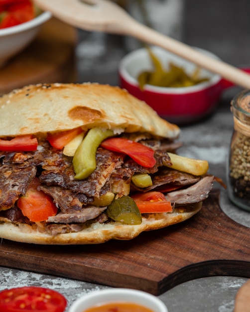 Hamburger with kebab meat, tomato and cucumber