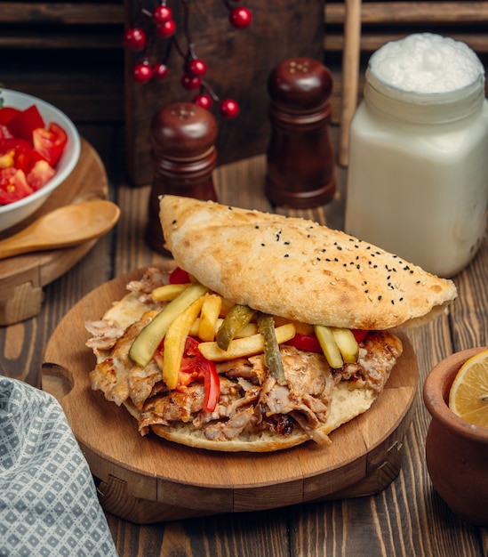 Hamburger with kebab meat, tomato and cucumber