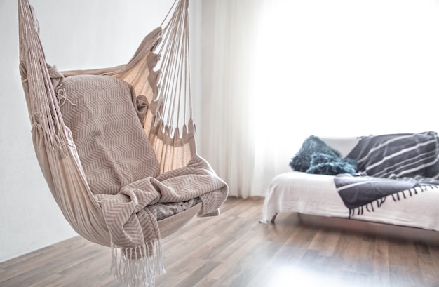 Free photo hammock chair in boho style. cozy interior. the concept of rest and home comfort. space for text.