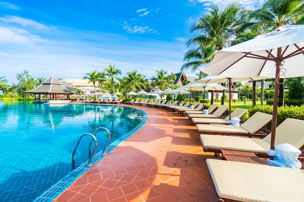 Hammocks and umbrella placed near to a large pool