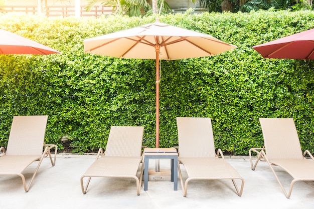 Free Photo hammocks and umbrellas in a plants background