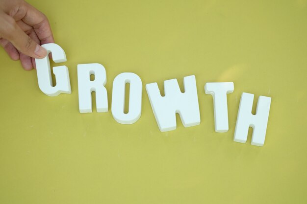 Hand arrange white letters as GROWTH