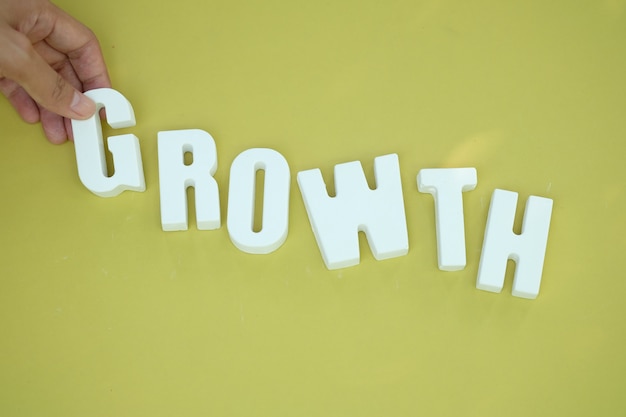 Hand arrange white letters as GROWTH