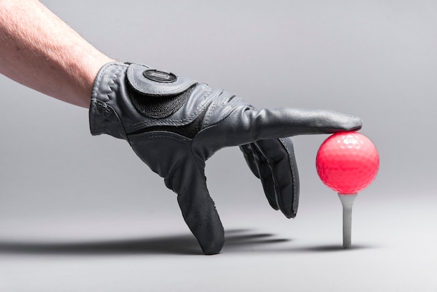 Hand arranging golf ball