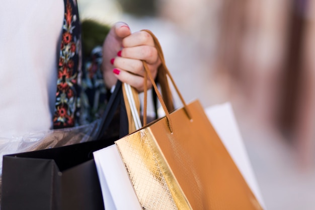 Free Photo hand carrying paper bags