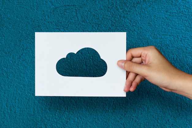 Free Photo hand hold cloud paper carving with blue background