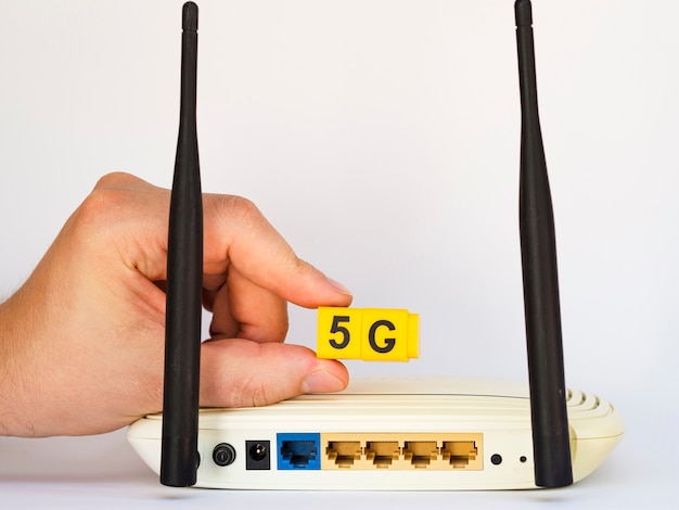 Hand holding 5g snap cubes above router