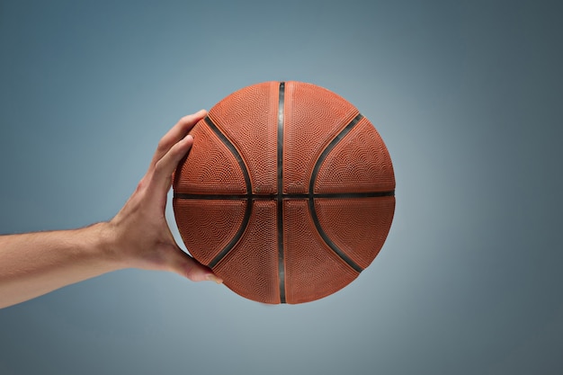 Hand holding a basket ball