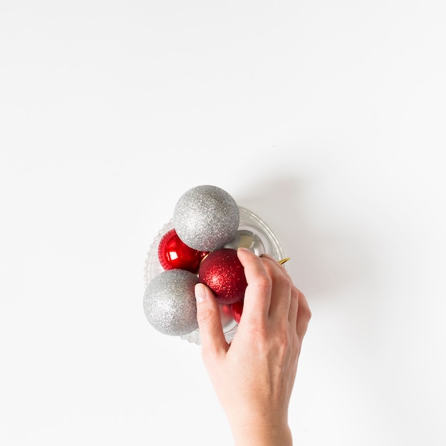 Free photo hand holding baubles on table