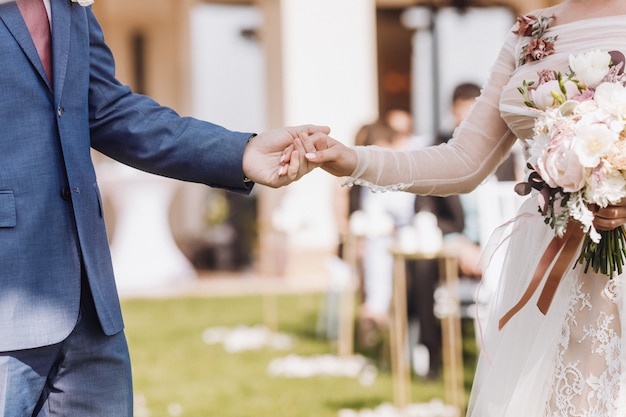 Hand holding a beautiful wedding couple