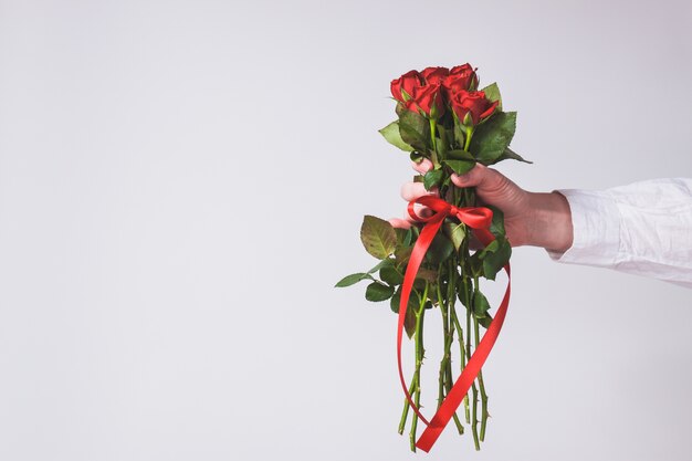 Hand holding a bouquet of roses