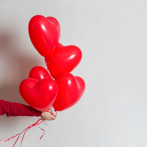 Hand holding a bunch of balloons