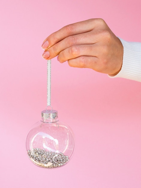 Free photo hand holding christmas ball