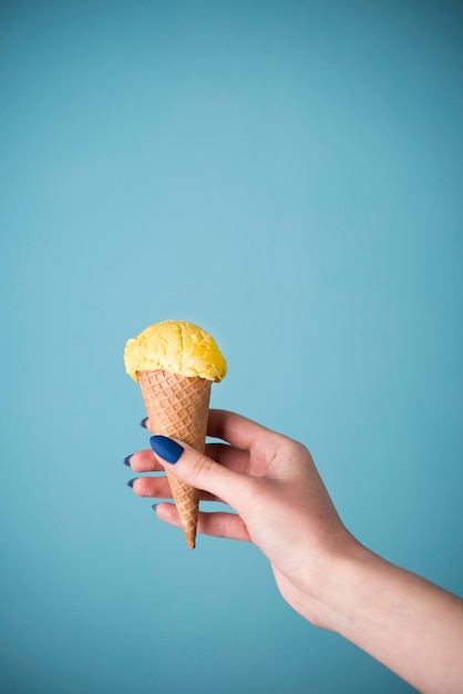 Hand holding delicious ice cream cone