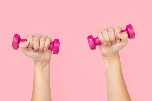 Free Photo hand holding dumbbells  in health and wellness concept