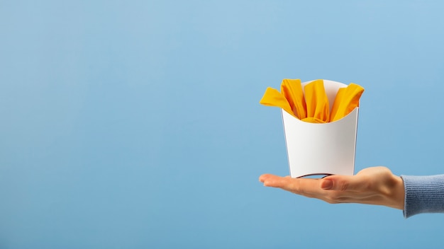 Hand holding fries made out of clothes