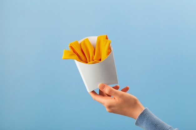 Free Photo hand holding fries made out of clothes