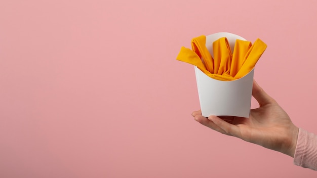 Hand holding fries made out of clothes