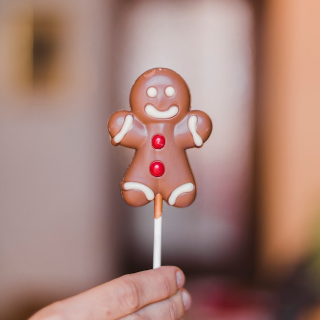 Free Photo hand holding gingerbread man