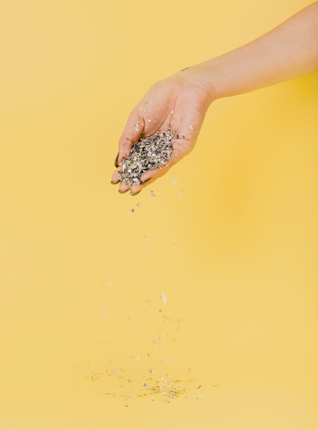 Free photo hand holding glitter with copy space