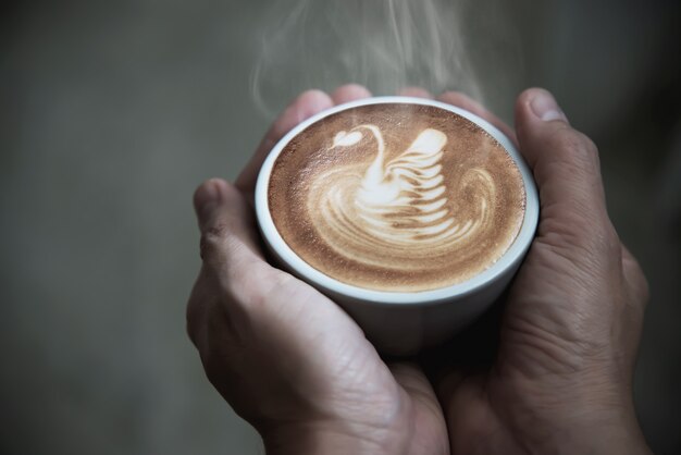 Hand holding hot coffee cup 