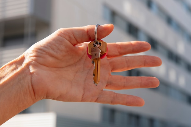 Hand holding keys outdoors