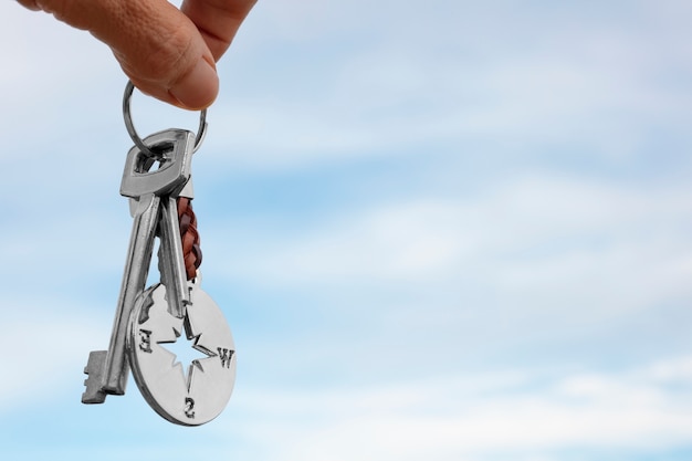 Free Photo hand holding keys outdoors