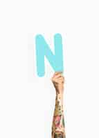 Free photo hand holding letter n sign