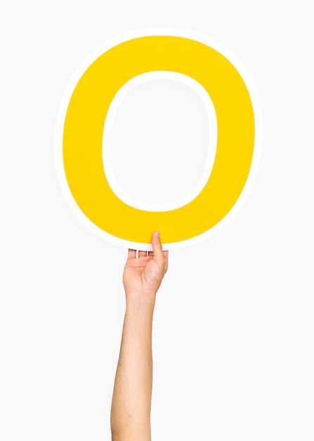 Free photo hand holding the letter o