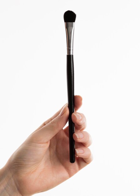 Hand holding make-up brush