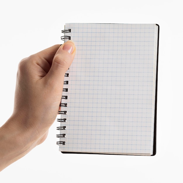 Free photo hand holding notebook