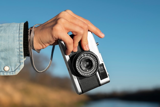 Free photo hand holding photo camera