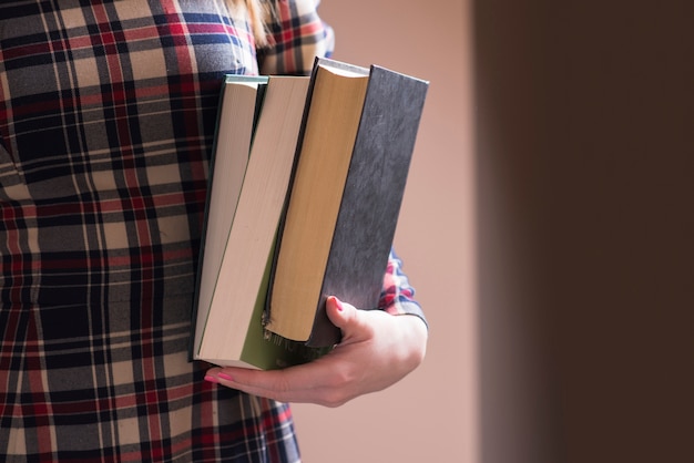 Free Photo hand holding several heavy books