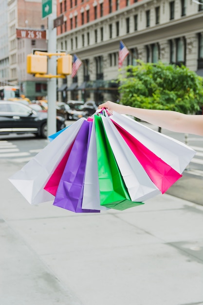 Hand holding shopping bags