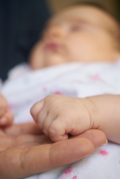 Hand holding small baby hand