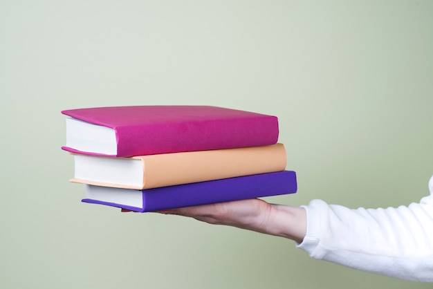 Free Photo hand holding three books