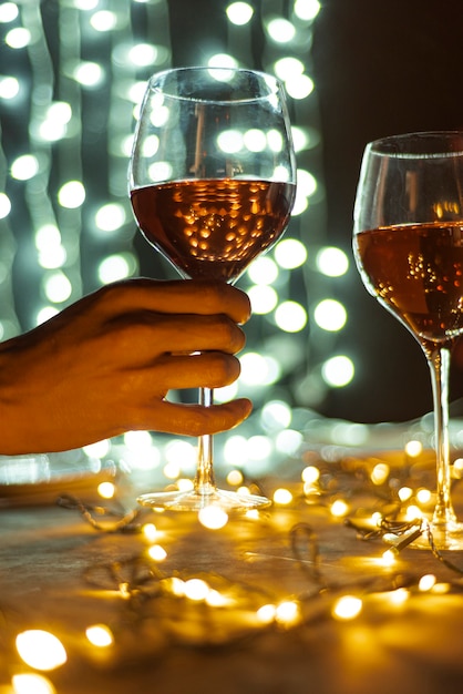 Hand holding transparent glass of wine