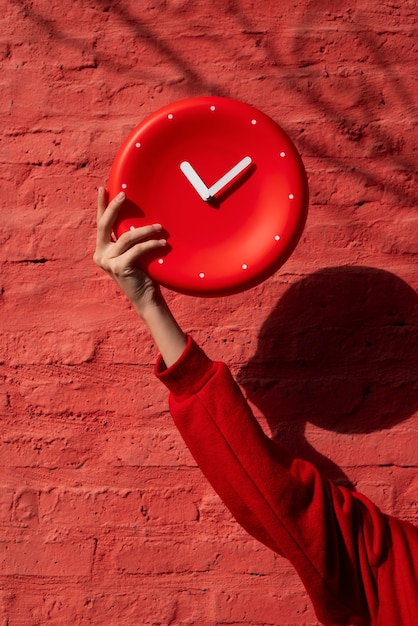 Hand holding wall clock still life