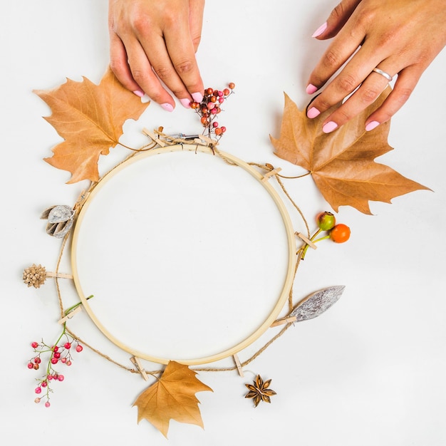 Hand making autumn wreath