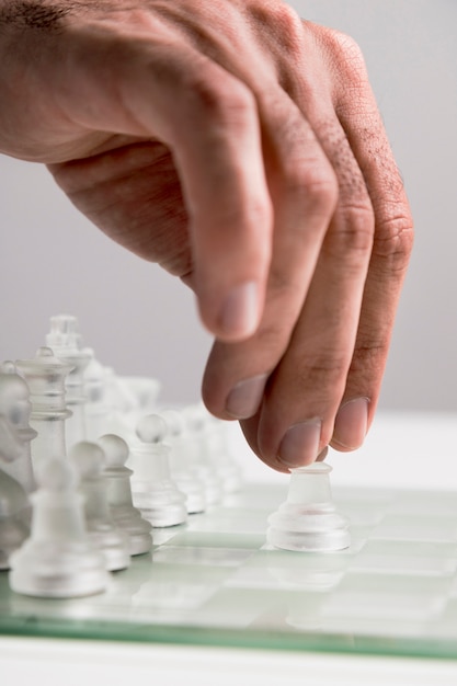 Hand moving transparent chess pieces