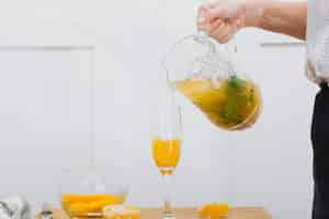 Free photo hand of person pouring lemonade