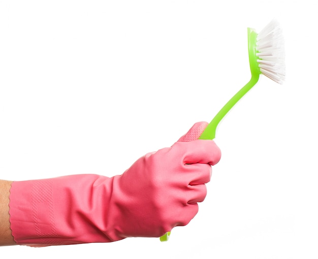 Hand in a pink glove holding brush