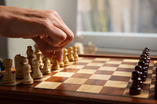 Free photo hand playing chess on classic board