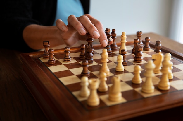 Free Photo hand playing chess on classic board