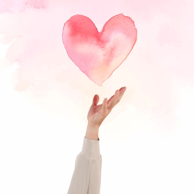 Free photo hand presenting heart for valentines’ celebration watercolor illustration