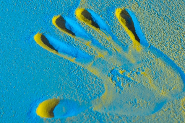 Hand shape in blue shades sand